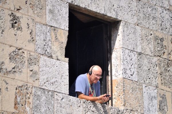 man listening to audiobook podcast music. photo zach mobrice